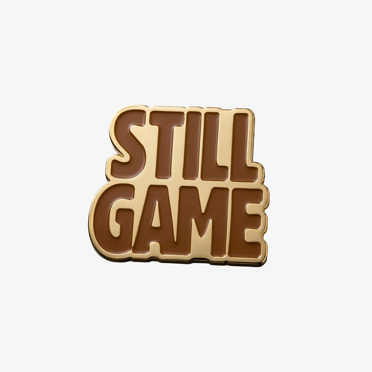 Gold coloured metal Fridge Magnet in the shape of the Still Game text.
