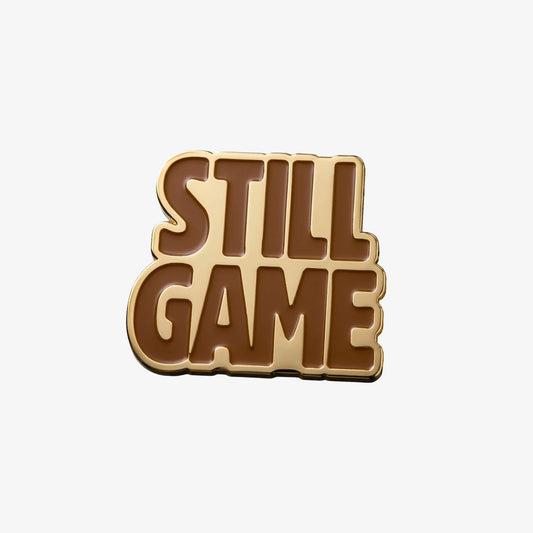 Gold coloured metal Fridge Magnet in the shape of the Still Game text.
