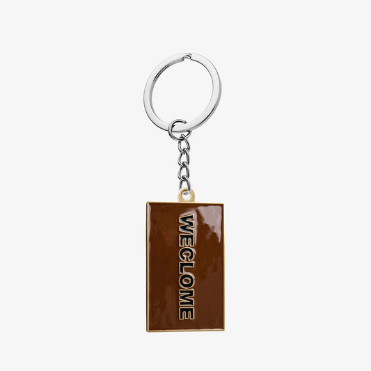 Soft enamel keyring in the shape of the Weclome Mat
