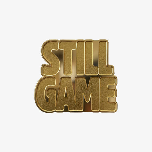 Gold coloured metal pin badge in the shape of the Still Game text.